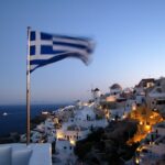 Flag of Greece waving at pole at Santorino, Greece