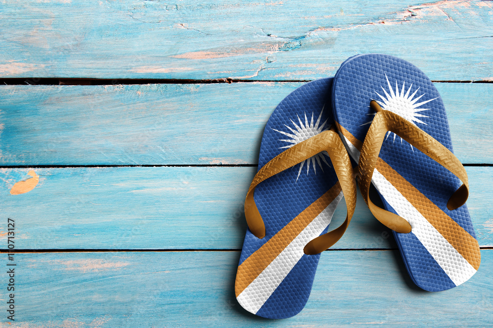 Thongs with flag of Marshall Islands, on blue wooden boards