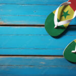 Pair of beach sandals with flag Senegal. Slippers for summer sea vacation. Concept travel and vacation in Senegal.