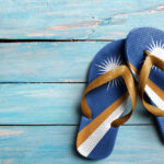 Thongs with flag of Marshall Islands, on blue wooden boards