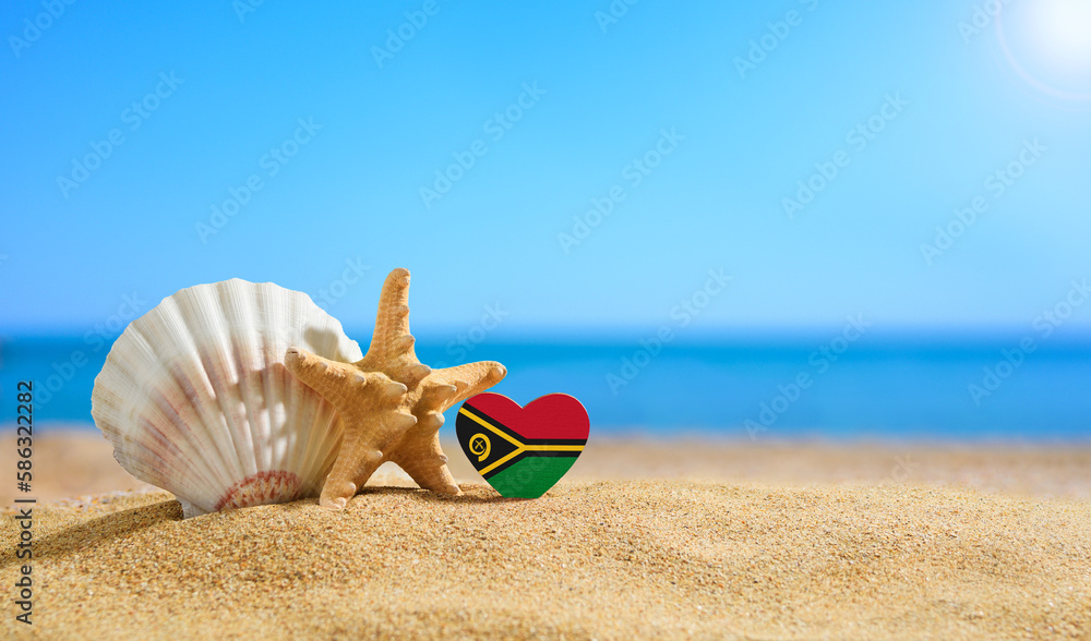 Beautiful beach in the Vanuatu. Flag of Vanuatu in the shape of a heart and shells on a sandy beach.